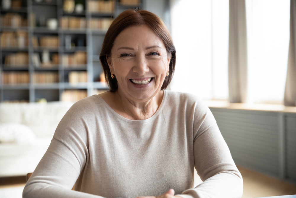 Head shot portrait smiling mature woman making video call - Dentures in Olympia WA